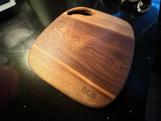BLOSM | Cutting Boart 12”x 9” with a eggplant / squash handle. Walnut. Designed and Handcrafted in California. - BLOSM | Blossom Woodworking